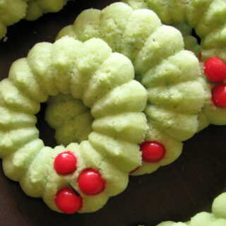 holly wreath spritz cookies on serving tray