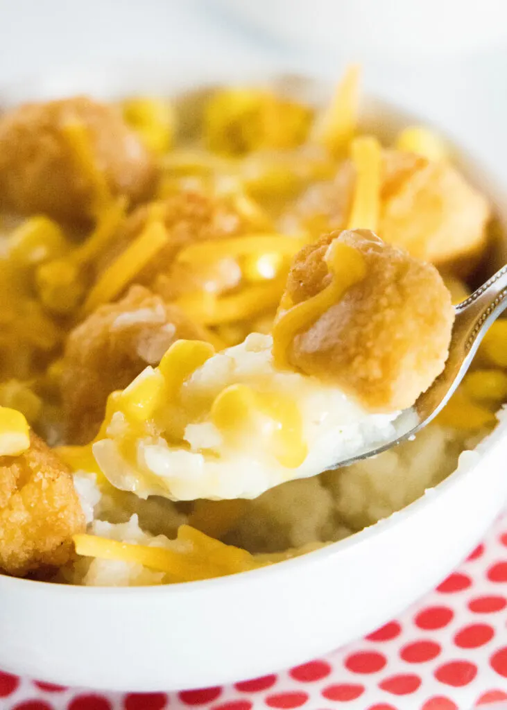 taking a bite of a homemade kfc bowl