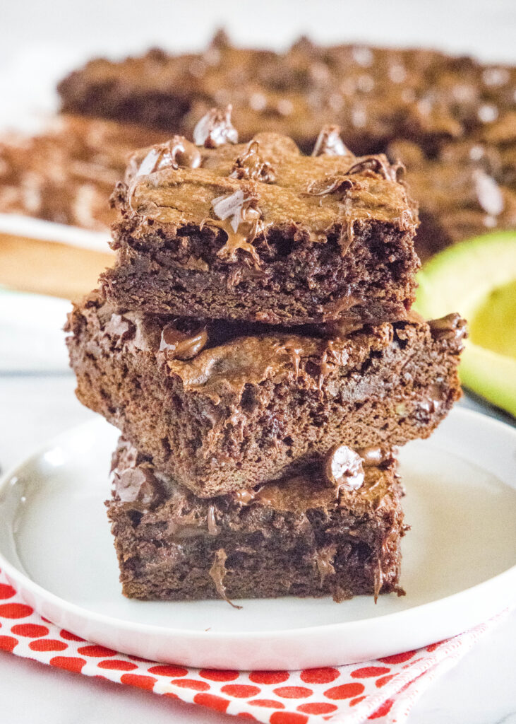 stacked avocado brownies on a white plate