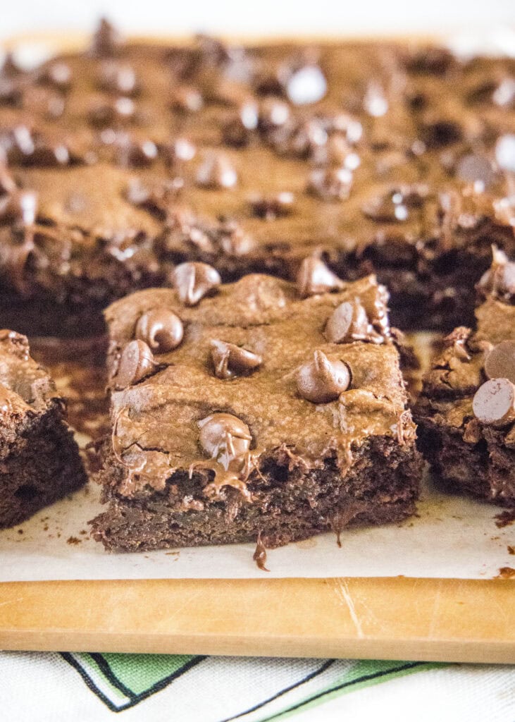 avocado brownies on a cutting board cut into squares