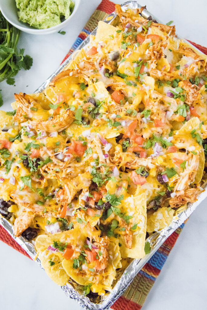 looking down on baking sheet with barbecue chicken nachos