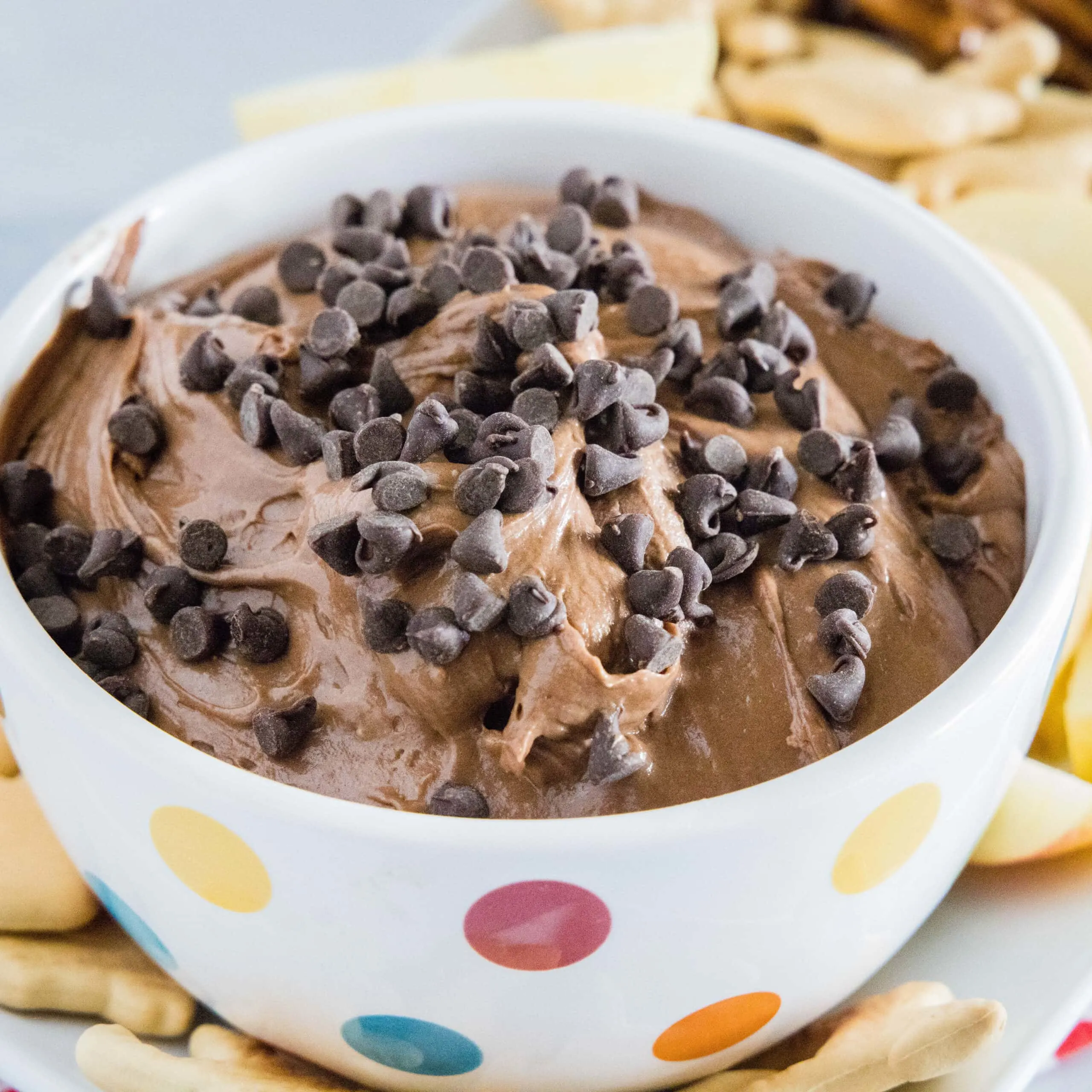 close up bowl of brownie batter dip topped with chocolate chips