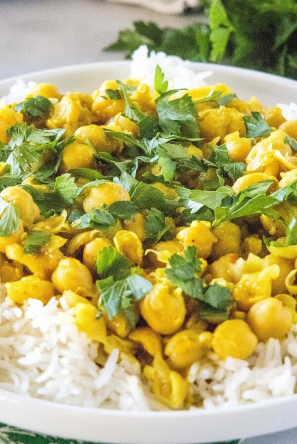 close up chickpea curry on a white plate