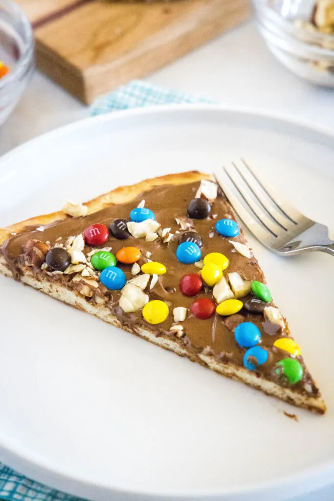 chocolate pizza on a white plate with a fork