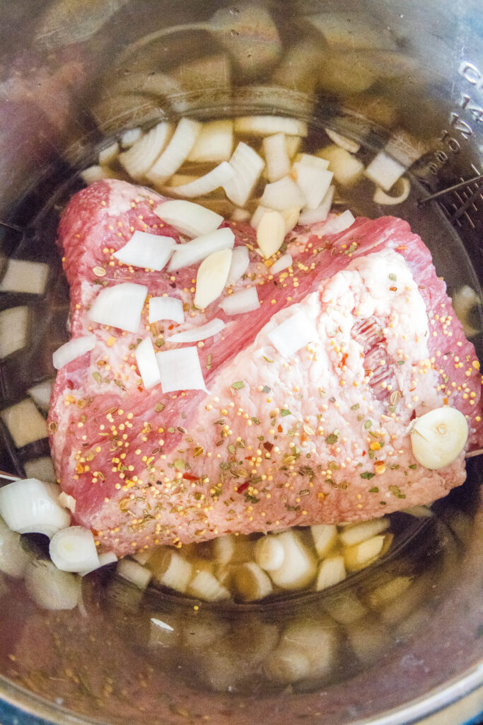 conred beef in the instant pot with onions and garlic