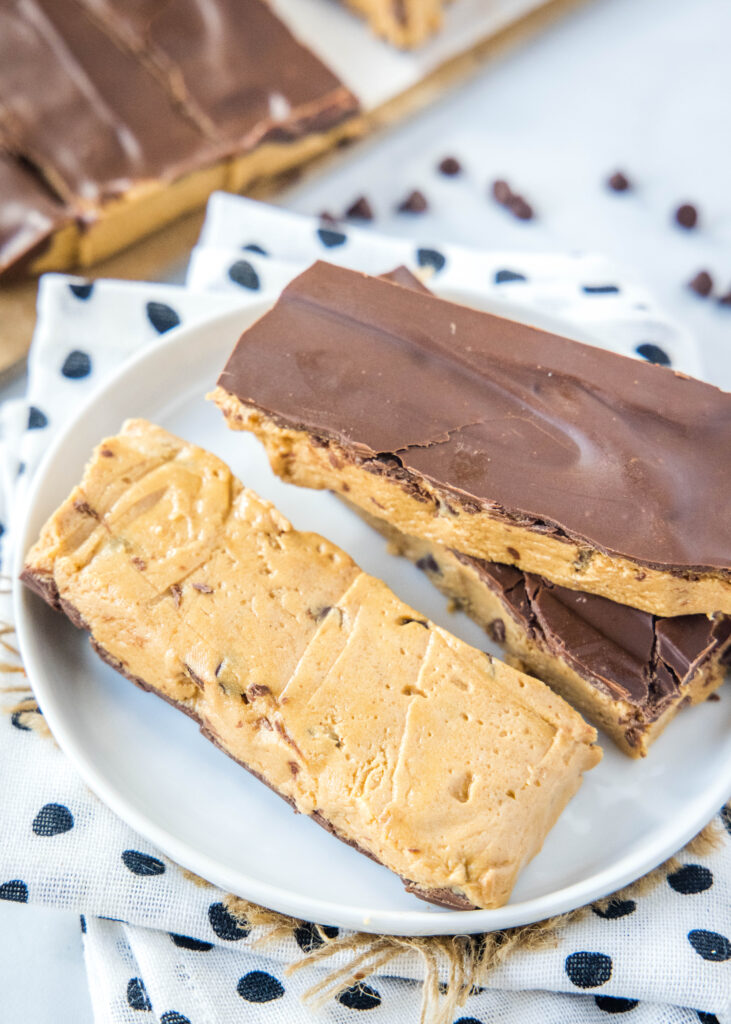 peanut butter protein bars on a plate, with 1 turned over to show the bottom