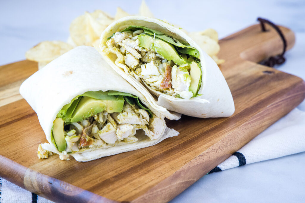 Chicken Pesto Wraps - super easy chicken wraps that you can make ahead or serve for a quick and easy dinner! Filled with chicken, cheese, pesto, tomatoes and more!