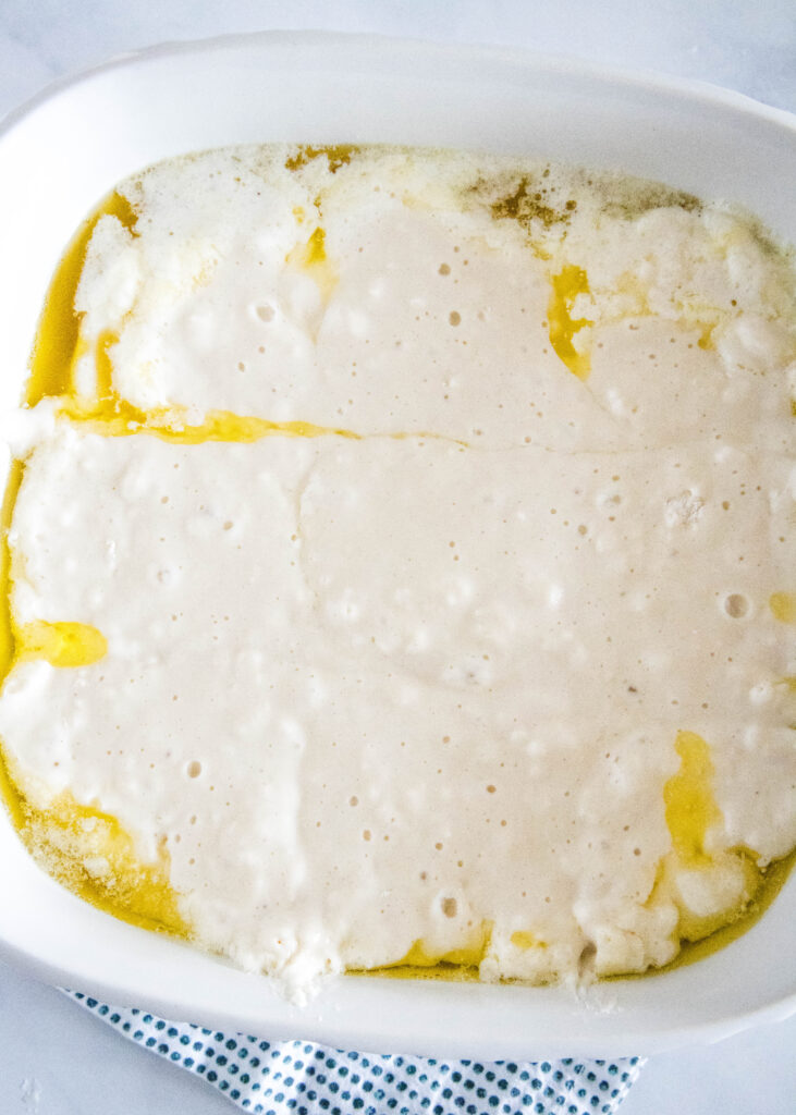 biscuit dough and melted butter in baking dish