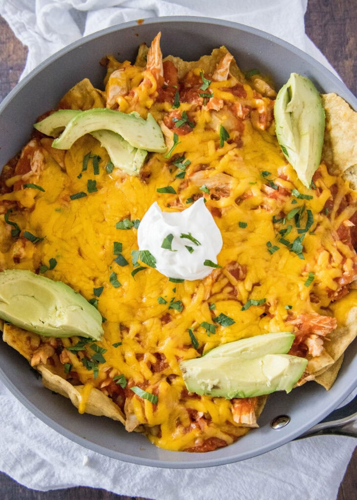 looking down on a skillet with baked chicken chilaquiles