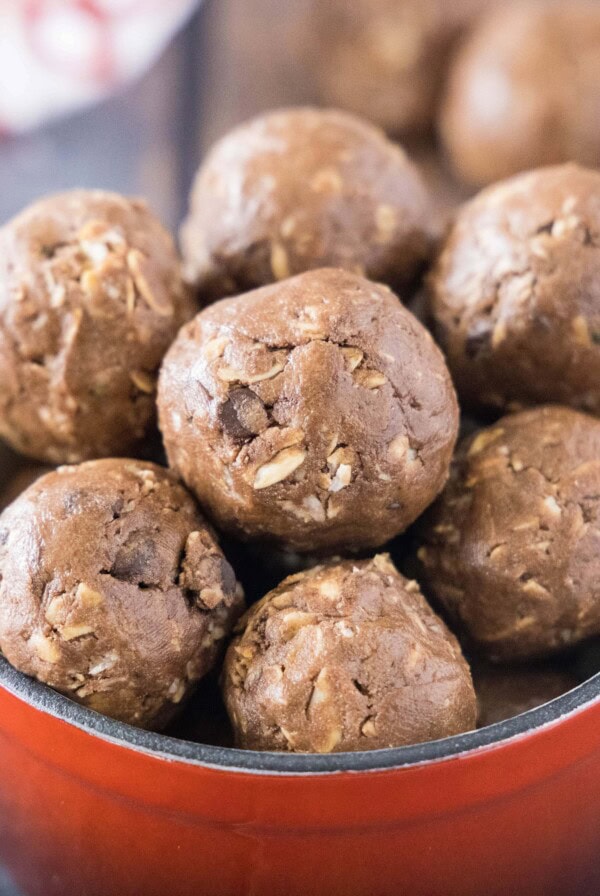 cropped square image of chocolate protein bites in a red bowl