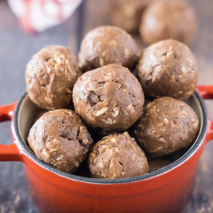 cropped square image of chocolate protein bites in a red bowl