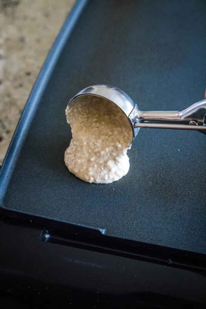 scooping pancakes onto a hot griddle