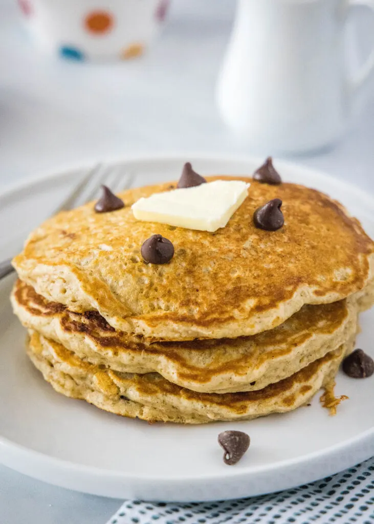 stack of oatmeal pancakes on a white plate