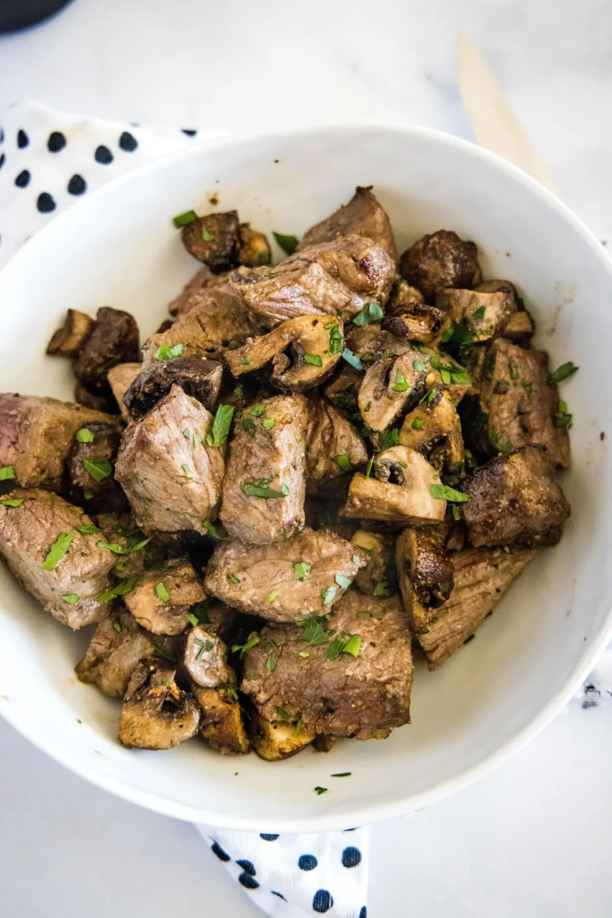 Overhead view of a bowl of steak and mushroom bites