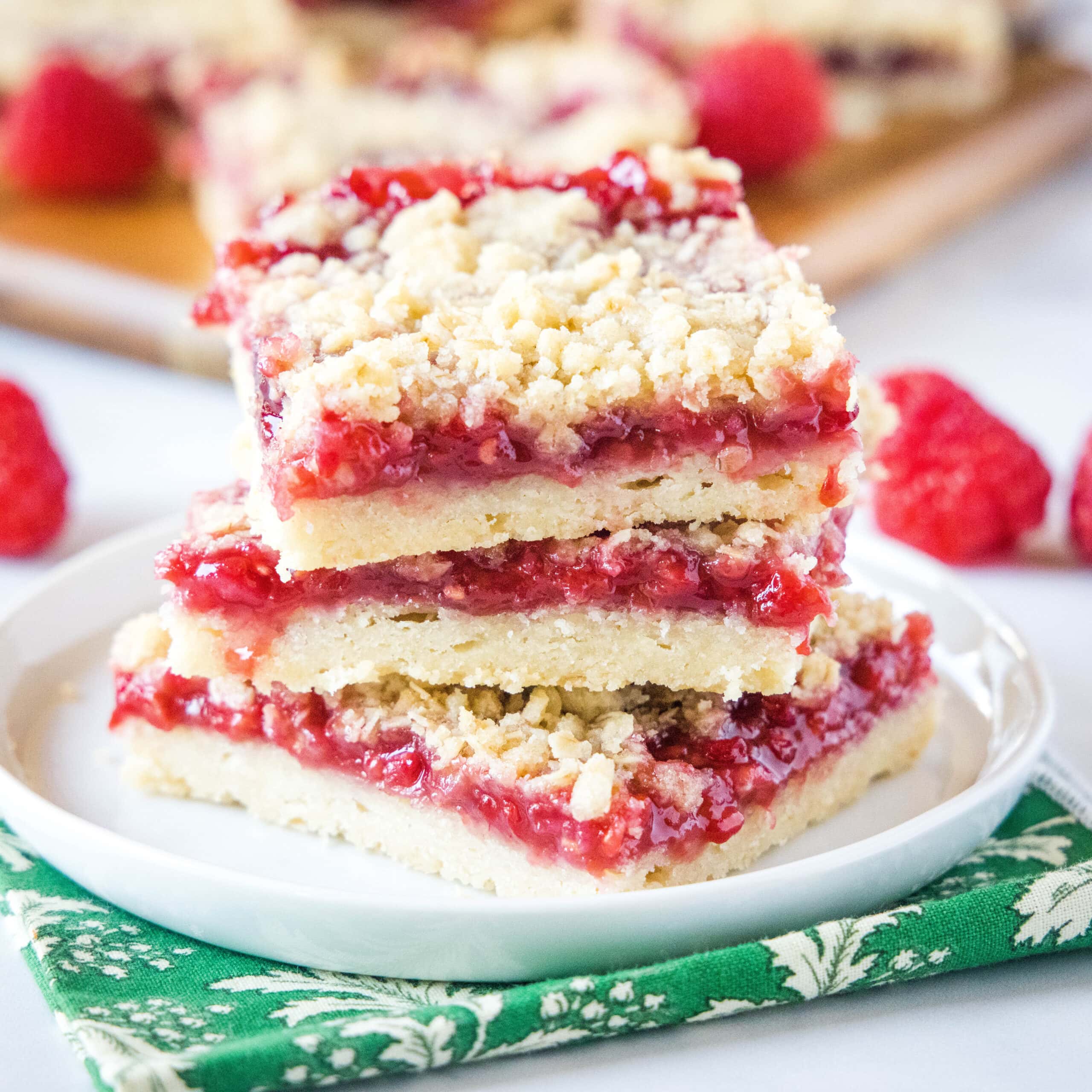 close up stack of raspberry bars on a white plate