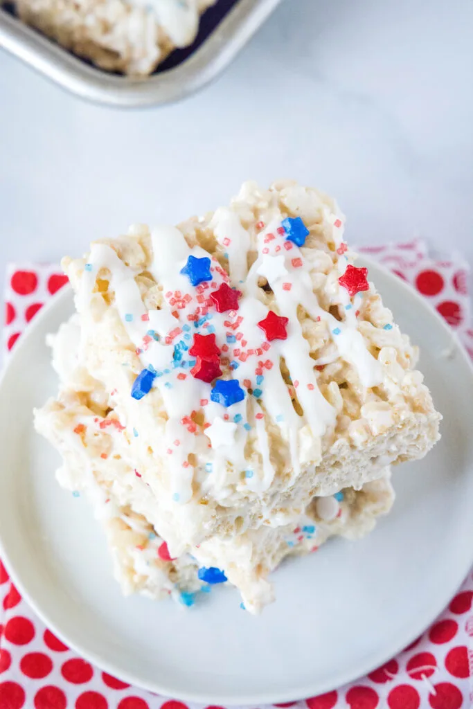 red white and blue rice krispie treats on a white plate