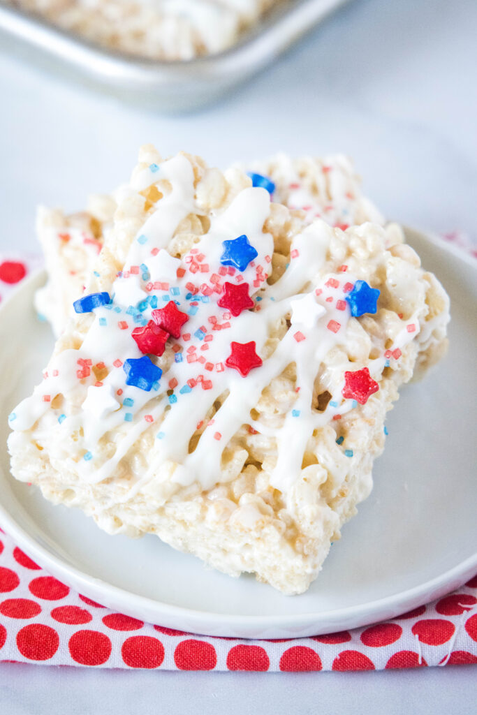 rice krispie treats decorated for the 4th of july on a white plate