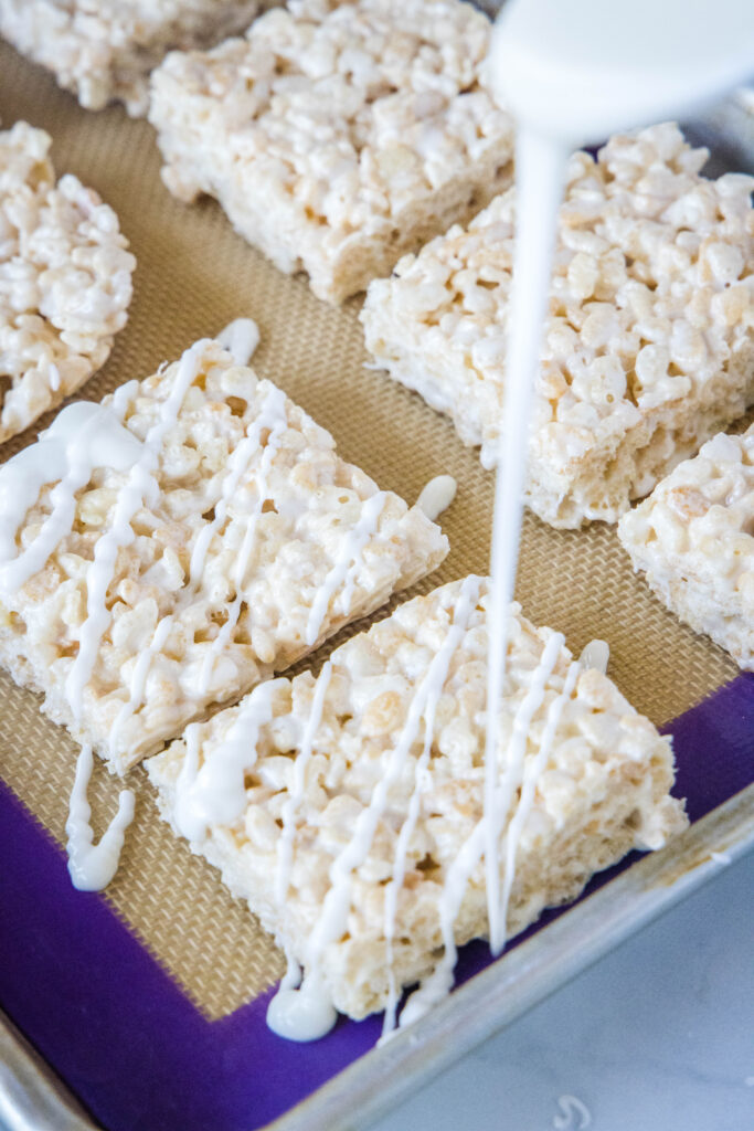 drizzling white chocolate on rice krispie treats