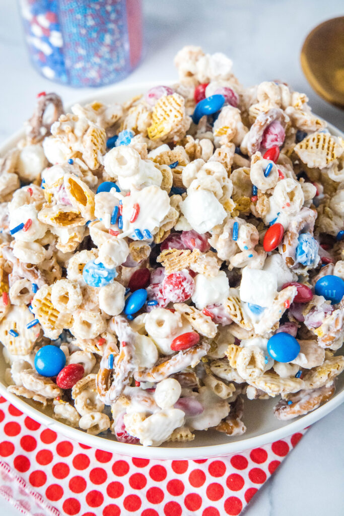 a white serving bowl of 4th of july snack mix