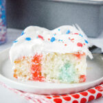 close up 4th of july poke cake on a plate