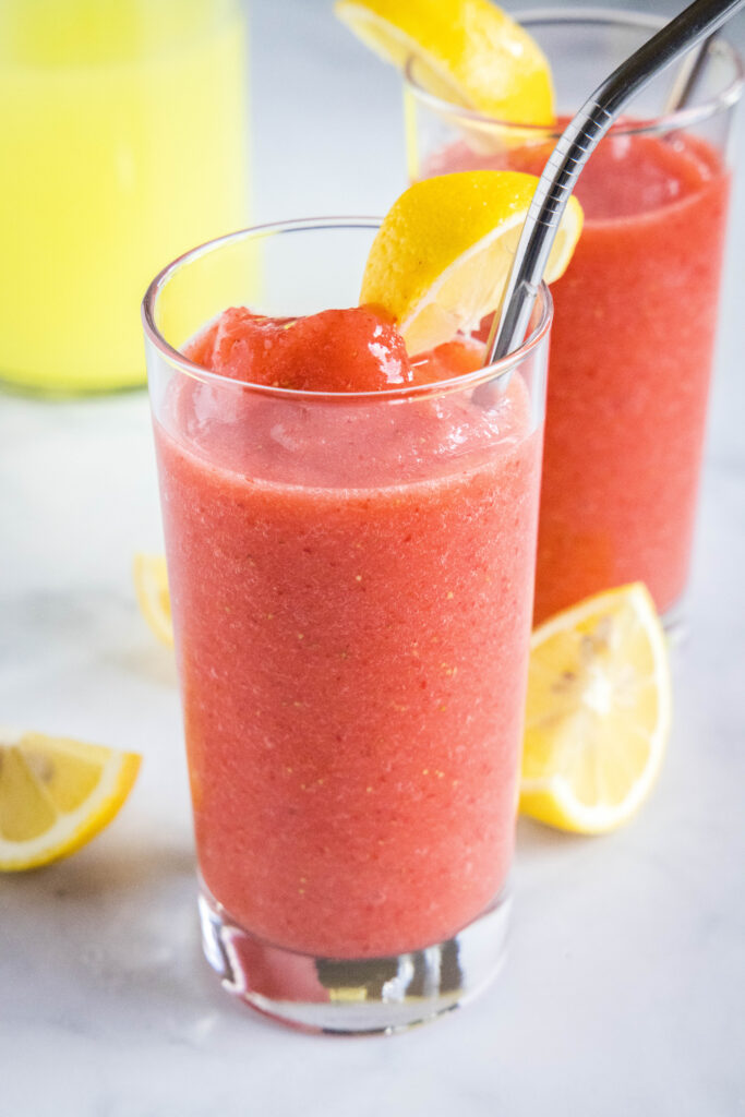 a tall glass with frozen strawberry lemonade