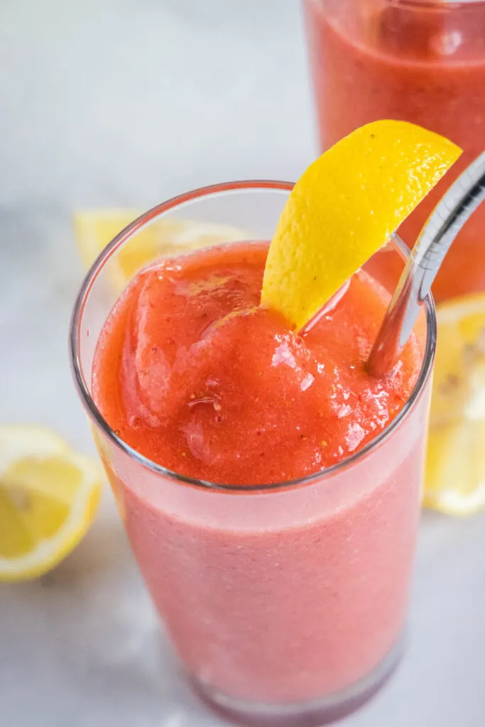 looking down on a glass filled with strawberry lemonade with a slice of lemon