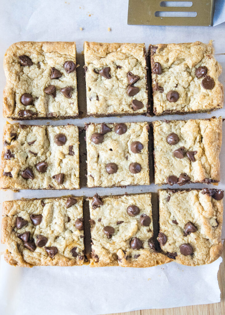 peanut butter chocolate chip blondies sliced on a cutting board