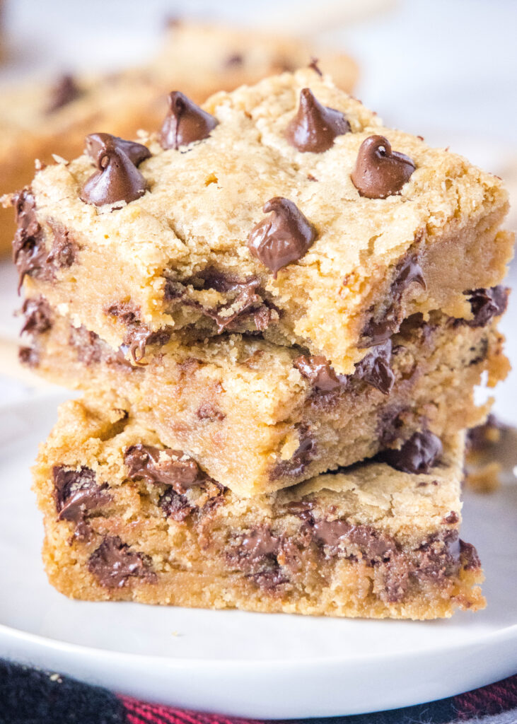 stacked peanut butter chocolate chip bars with a bite out of one