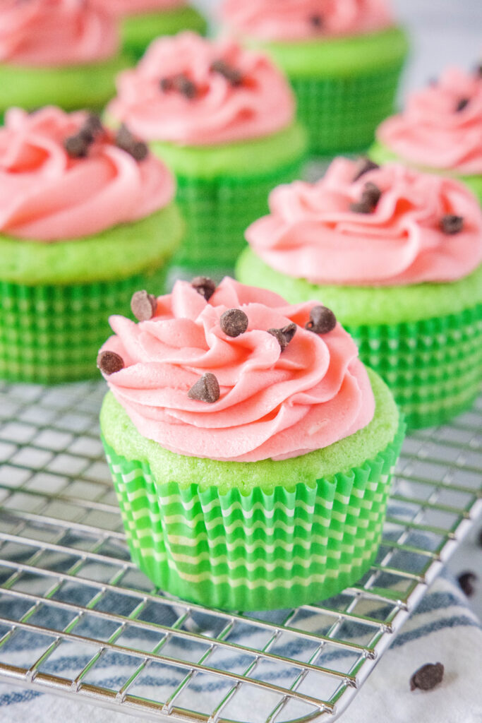 decorated watermelon cupcakes on a cooling wrack