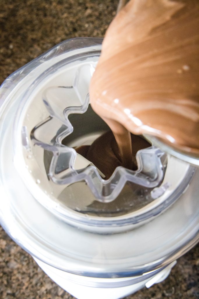 pouring chocolate ice cream into ice cream maker