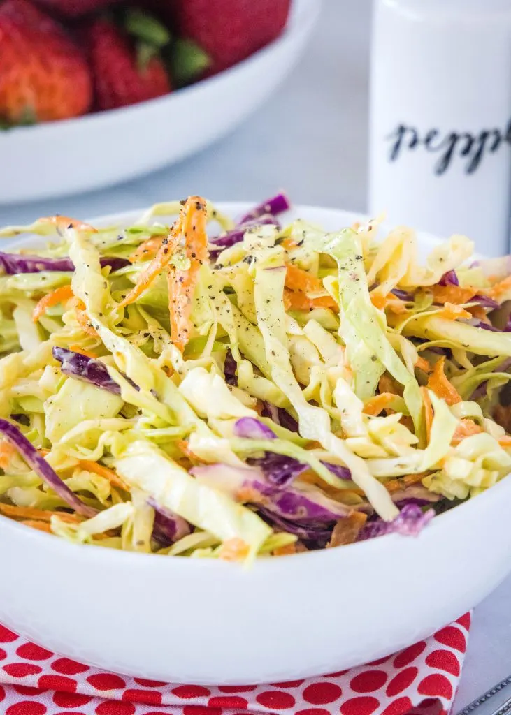 creamy coleslaw in a white serving bowl