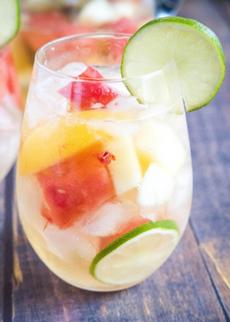 glass of white wine sangria with summer fruit