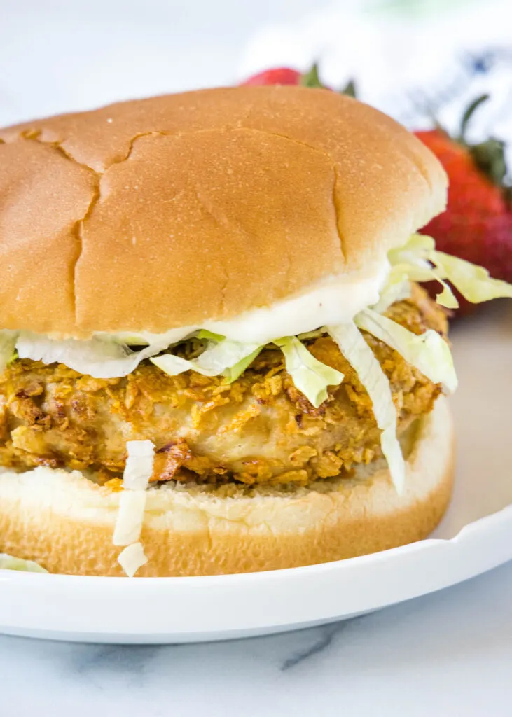 chicken sandwich with mayo and lettuce on a plate
