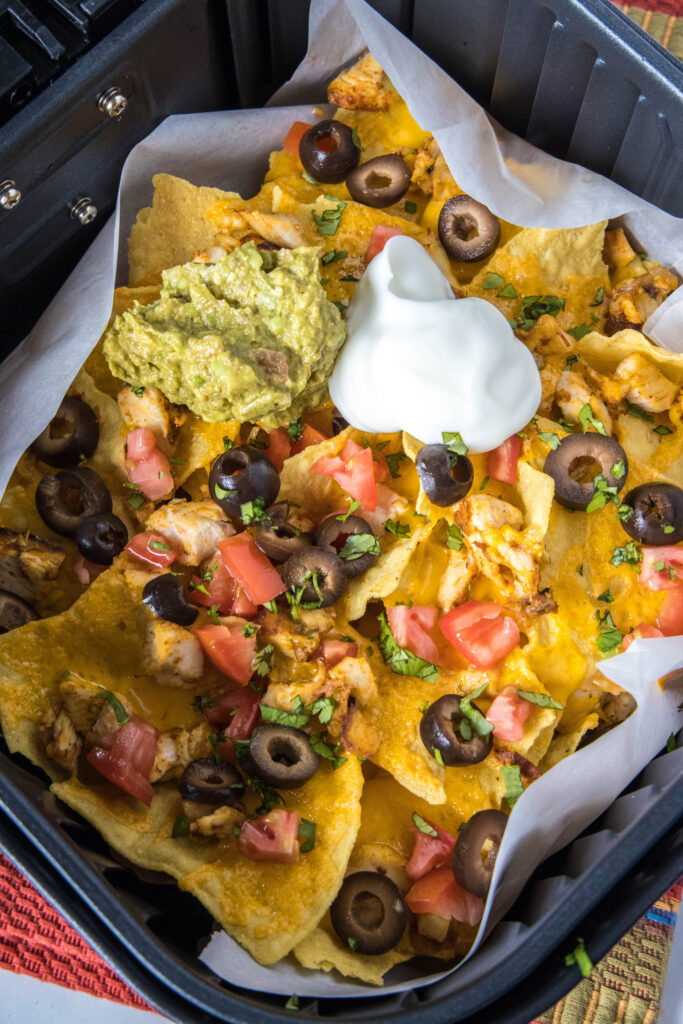 air fryer nachos topped with toppings