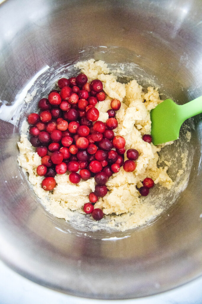 adding cranberries to cake batter