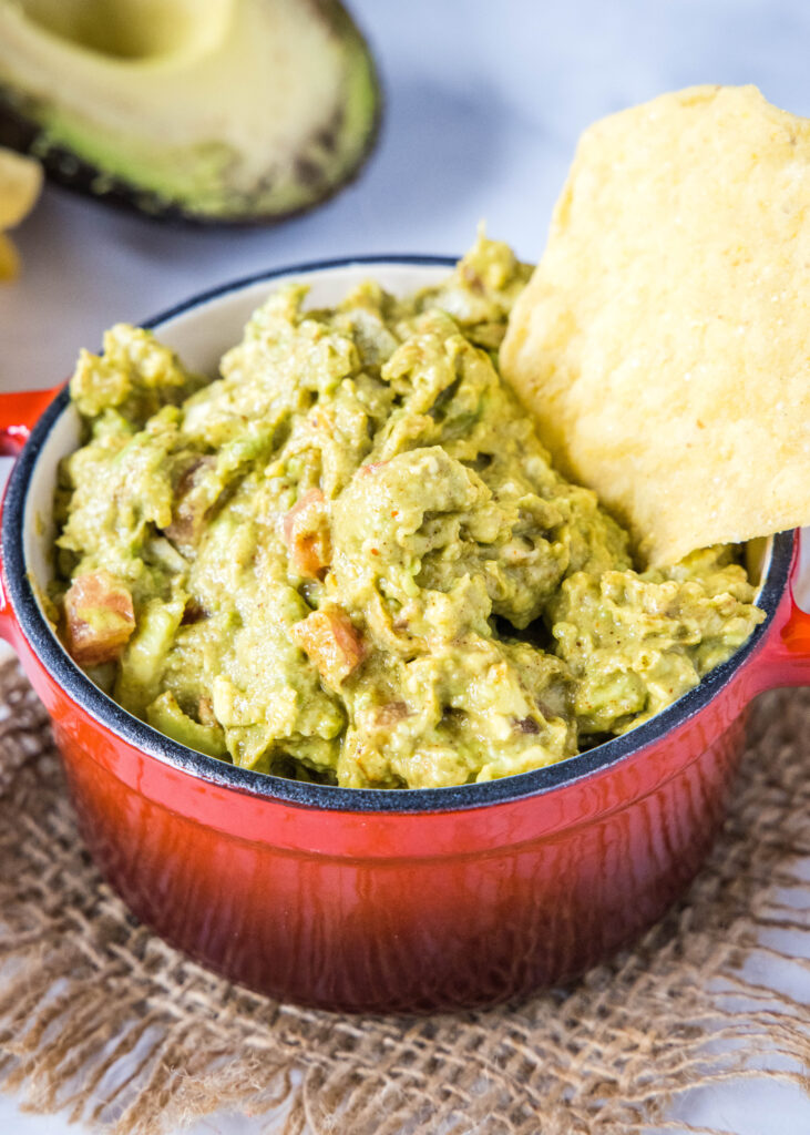 guacamole in a bowl with a chip
