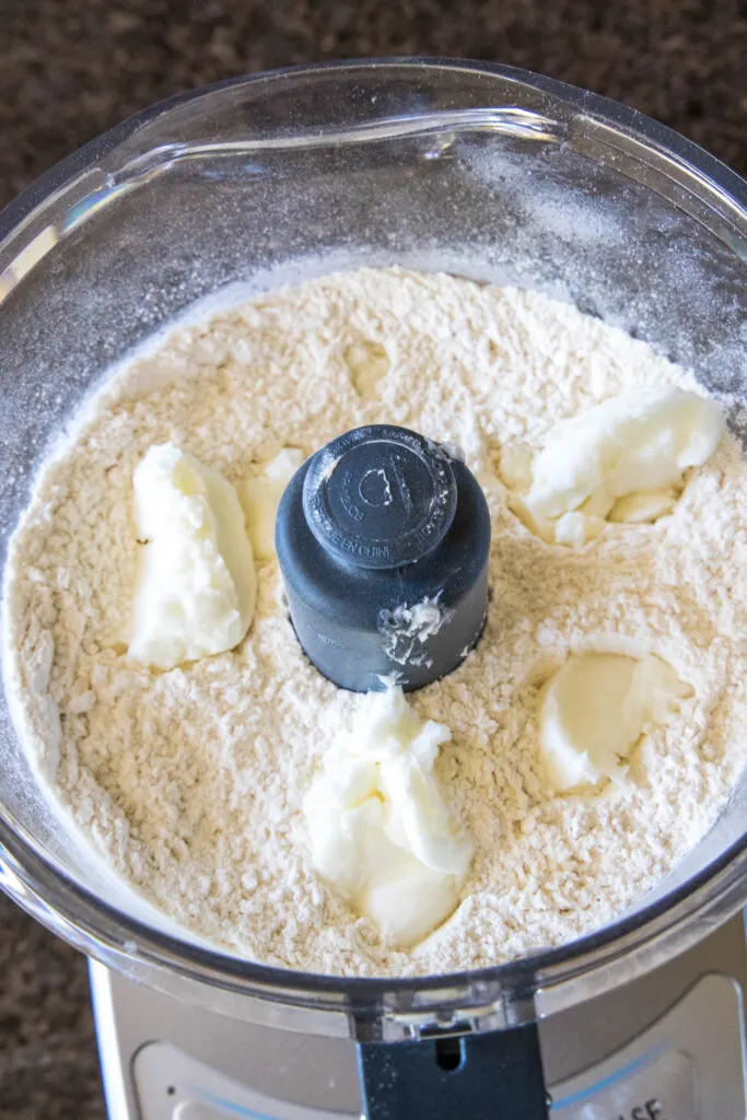 adding shortening to food processor with flour