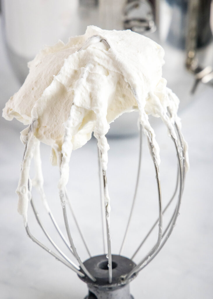A whisk covered in Cool Whip
