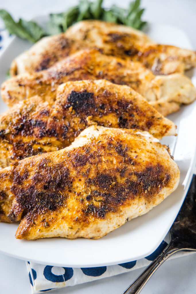 plate with cooked chicken breasts with blackened seasoning