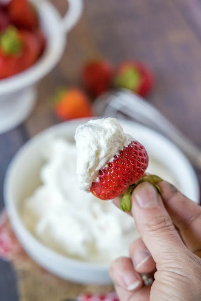 a strawberry dipped in whipped cream