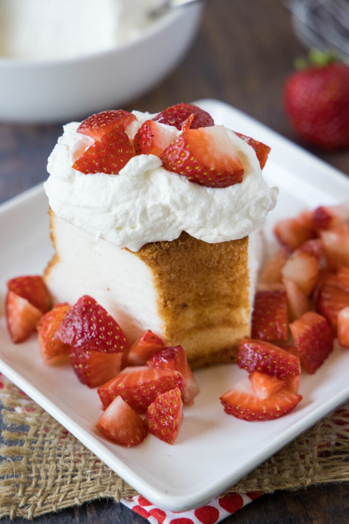 whipped cream on angel food cake with strawberries