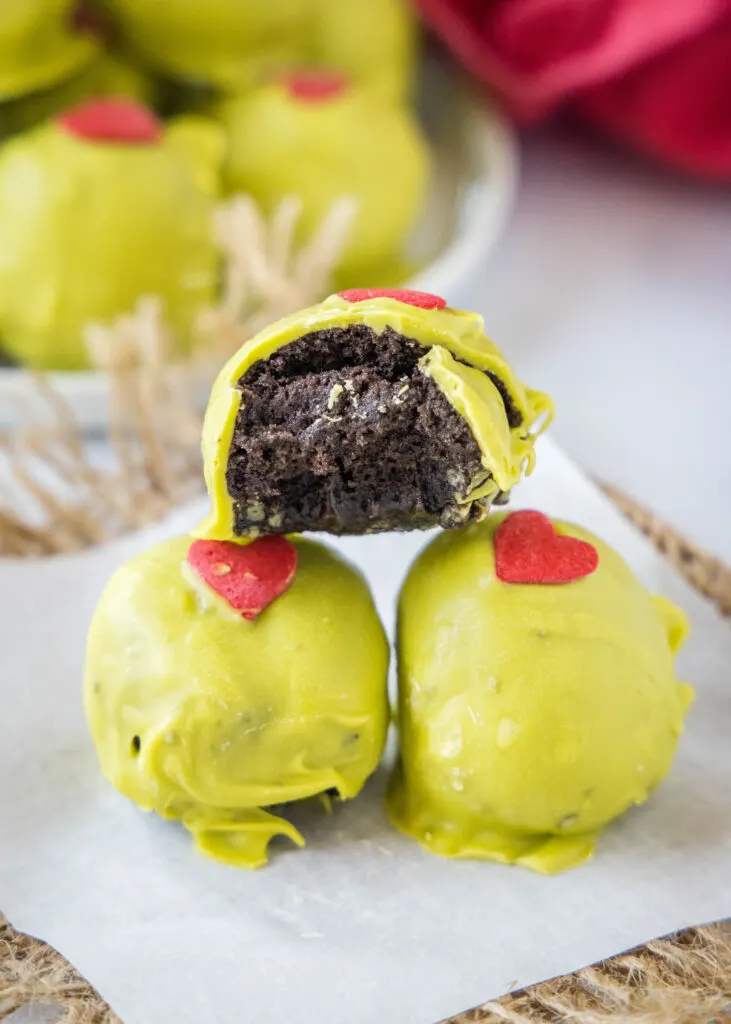 grinch truffles with a bite taken out of one
