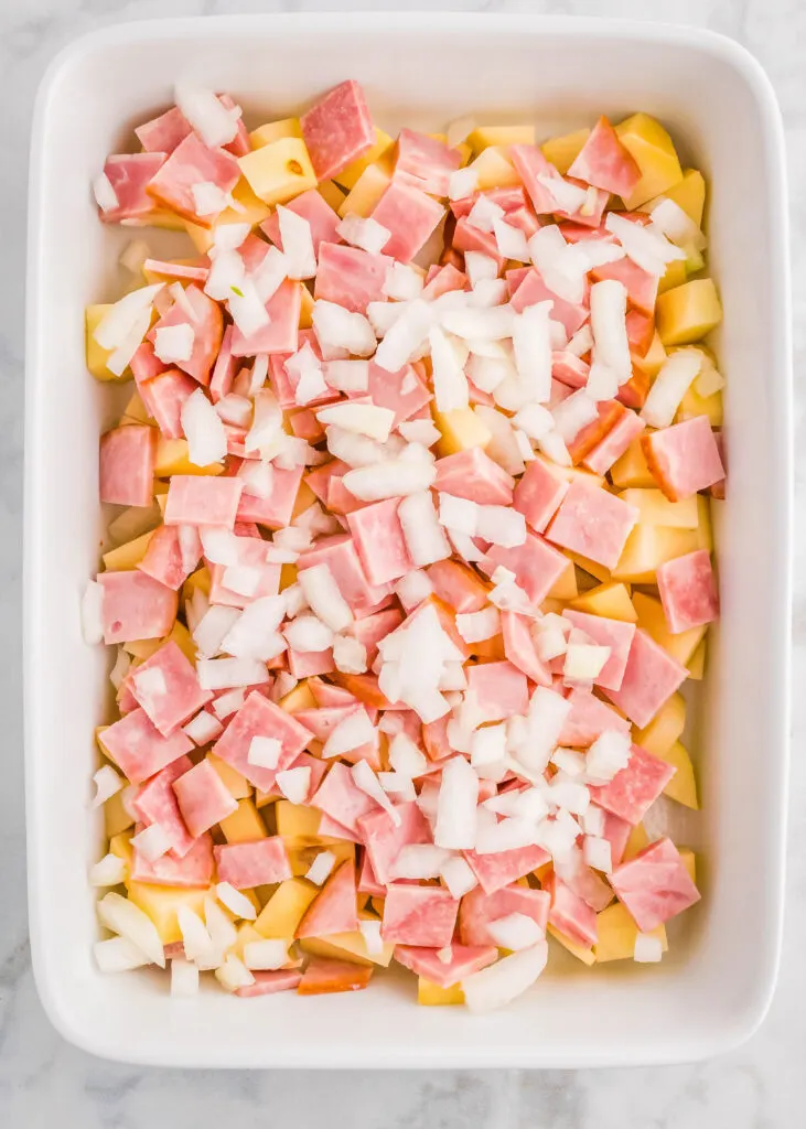 layering ham potatoes and onions in casserole dish