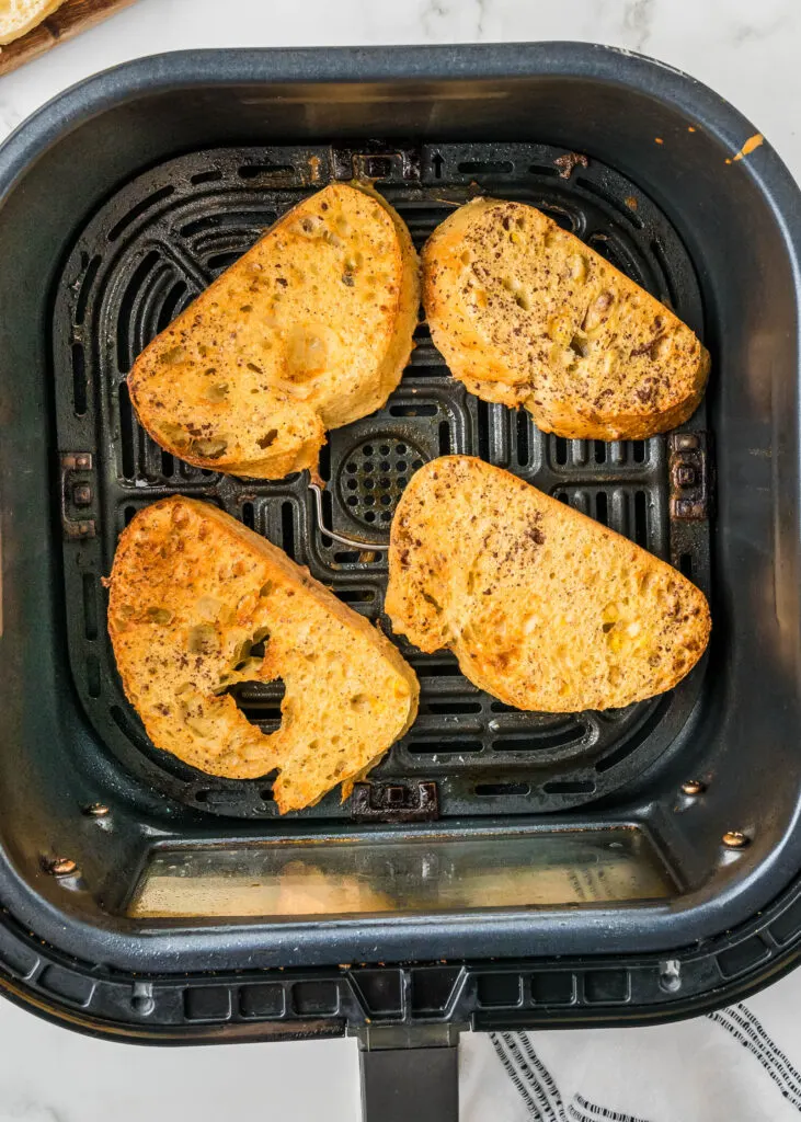 french toast being cooked in the air fryer basket