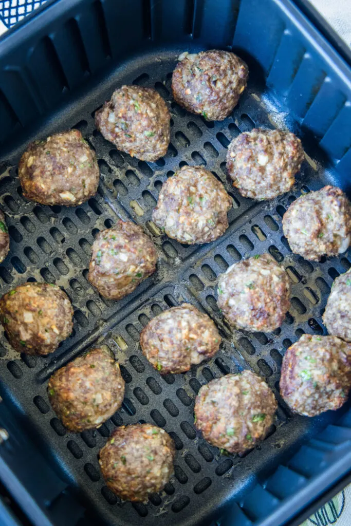 Overhead view of meatballs in an air fryer basket