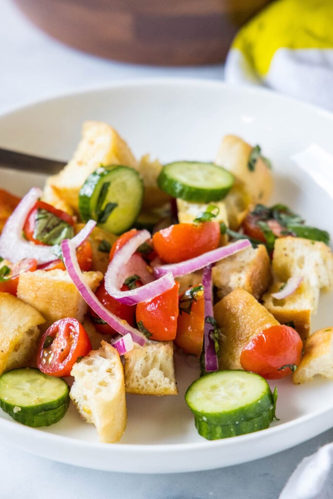 a white plate with panzanella salad