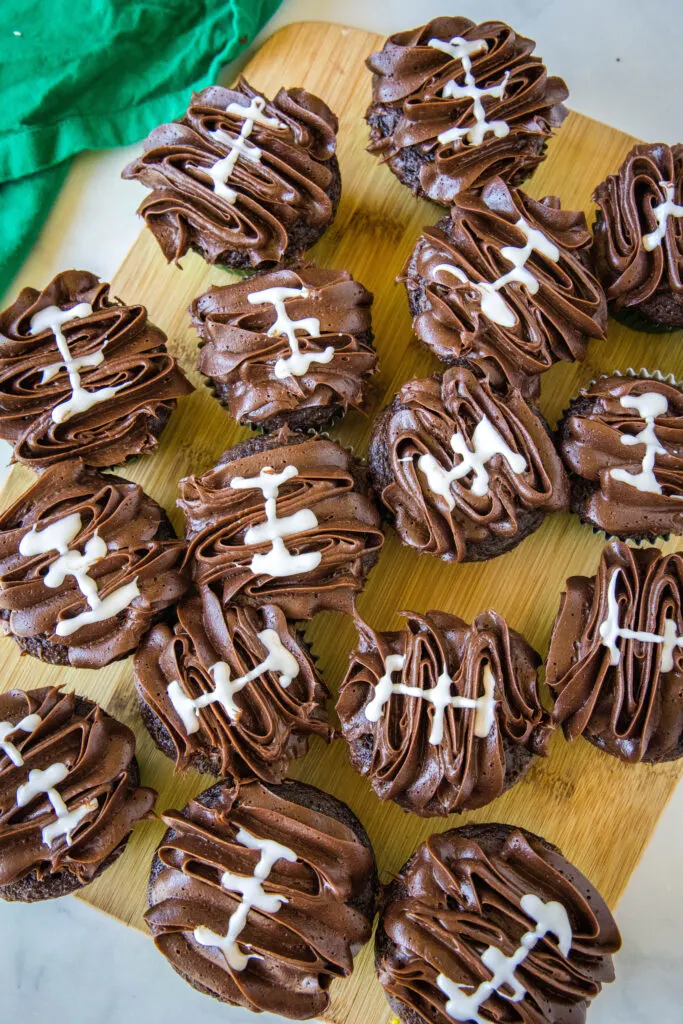 looking down on a tray of chocolate football cupcakes