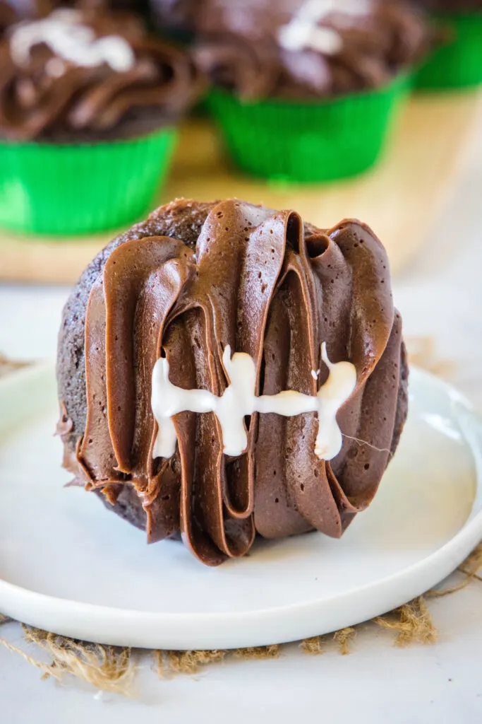 white plate with chocolate football cupcake