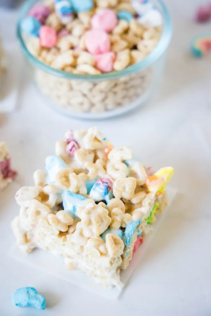 lucky charms krispie treats cut into pieces on counter