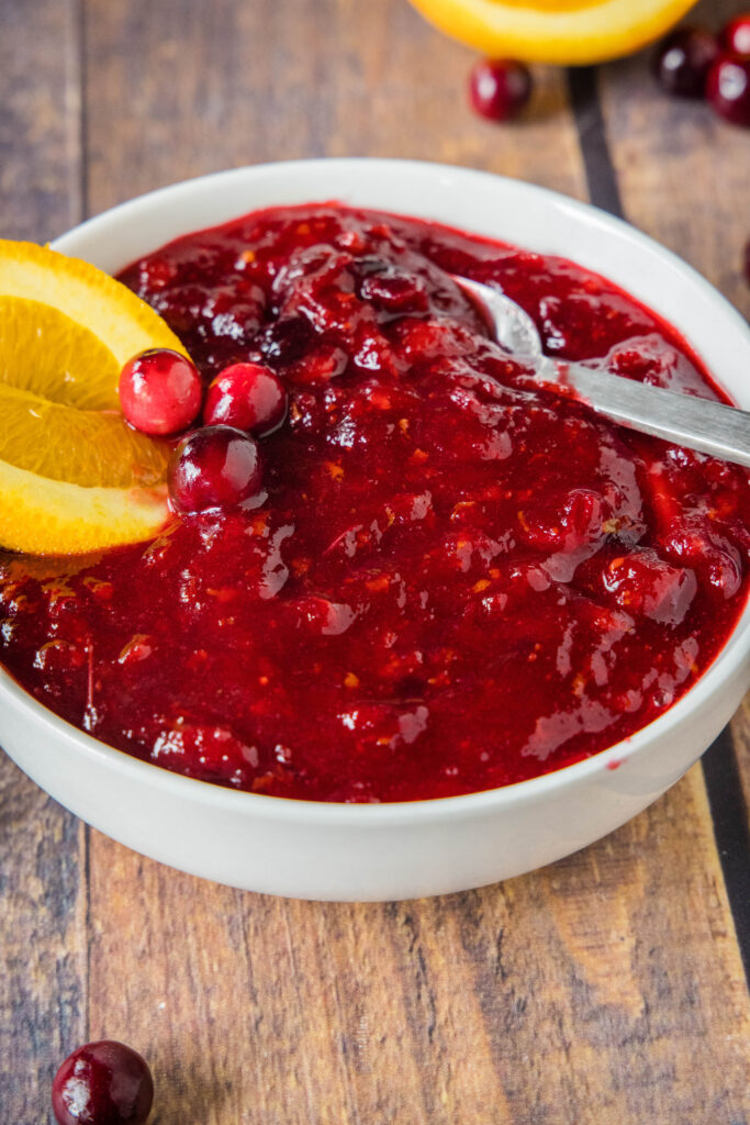 a spoon sitting in a bowl of cranberry sauce